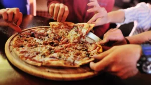 guests grabbing a slice of pizza at Shirky's Pizza Zone