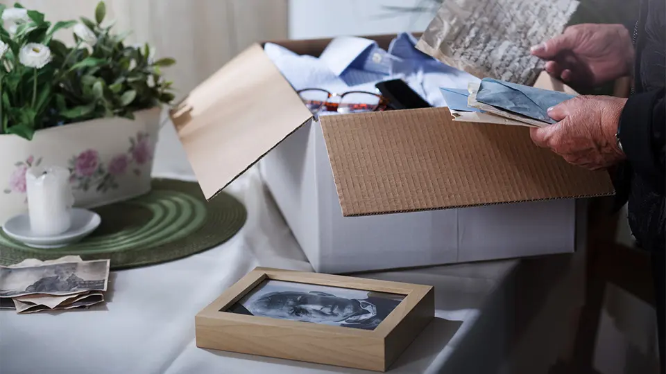 person looking at items store in a box